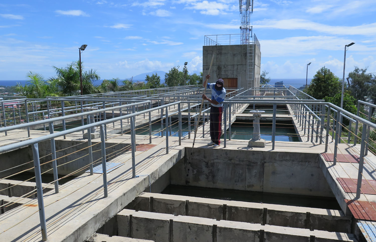 Water purification plant in Timor-Leste with worker in the foreground