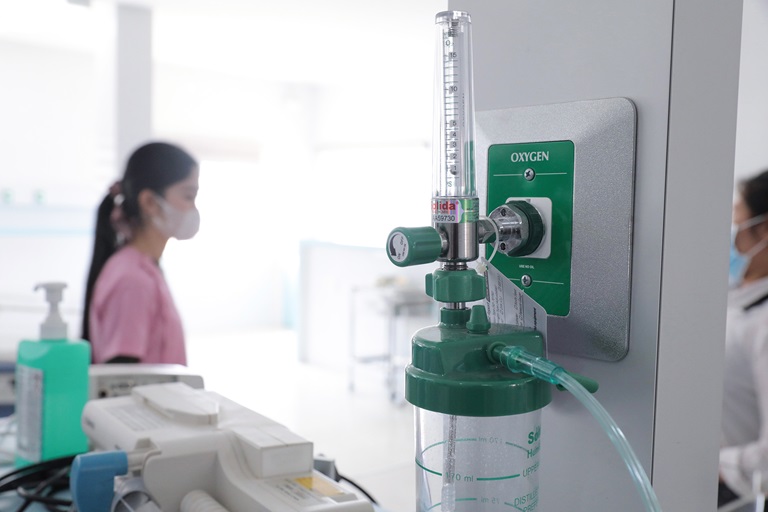 man checking the oxygen tanks