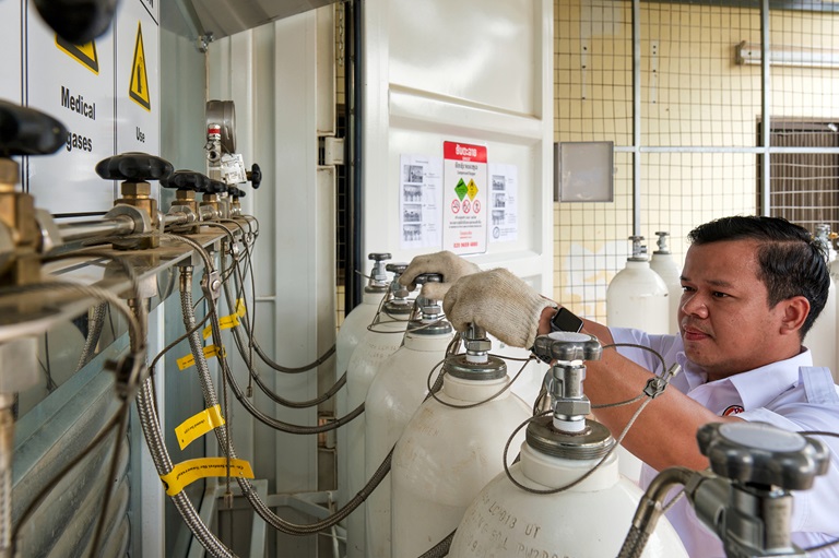 man checking the oxygen tanks