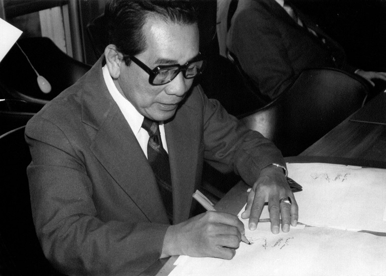 Dr Jesus Azurin, Undersecretary of the Department of Health and member of the Global Commission for the Certification of Smallpox Eradication, formally signs the document declaring "that smallpox has been eradicated in every country in the world.”