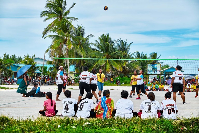 People playing sand volleyball
